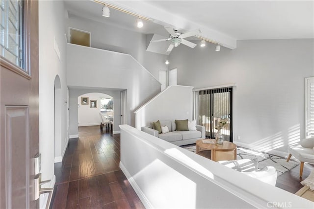 living room featuring dark wood-type flooring, ceiling fan, a wealth of natural light, and high vaulted ceiling