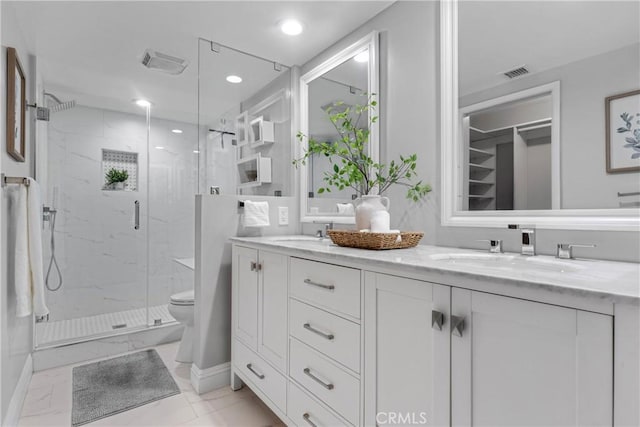 bathroom featuring walk in shower, vanity, and toilet