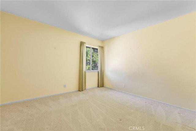 unfurnished room featuring light colored carpet