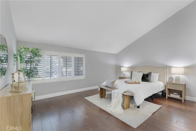 bedroom with lofted ceiling and dark hardwood / wood-style floors