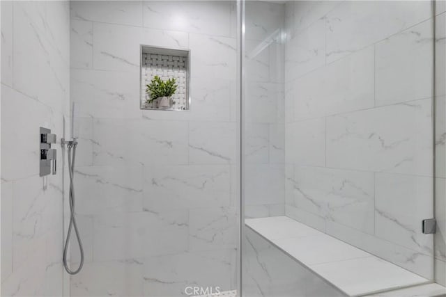 bathroom with tiled shower