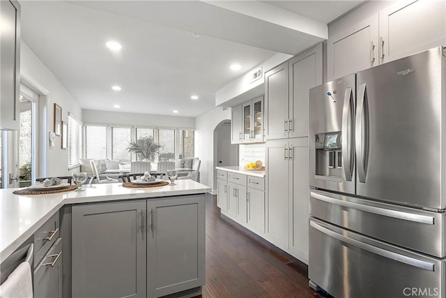 kitchen with dark wood-type flooring, stainless steel fridge, and gray cabinets