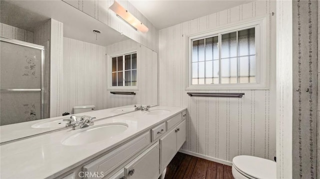 bathroom with toilet, wood-type flooring, walk in shower, and vanity