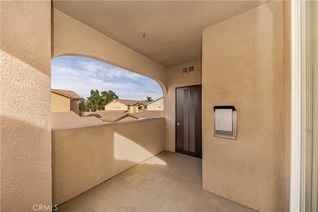 view of patio featuring a balcony