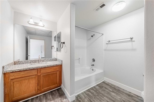 bathroom featuring vanity, shower / washtub combination, and hardwood / wood-style floors