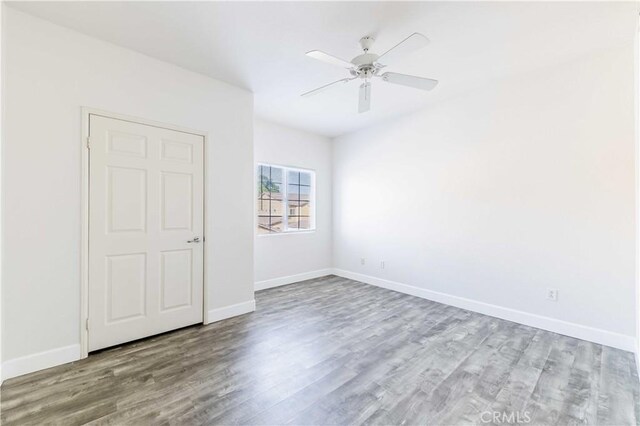 unfurnished bedroom featuring ceiling fan and light wood-type flooring