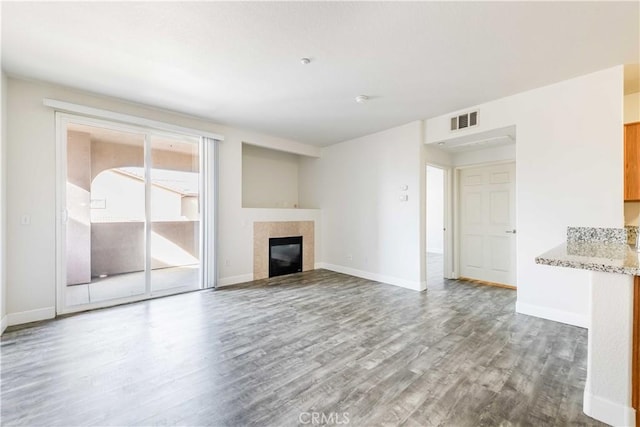 unfurnished living room with hardwood / wood-style floors and a fireplace