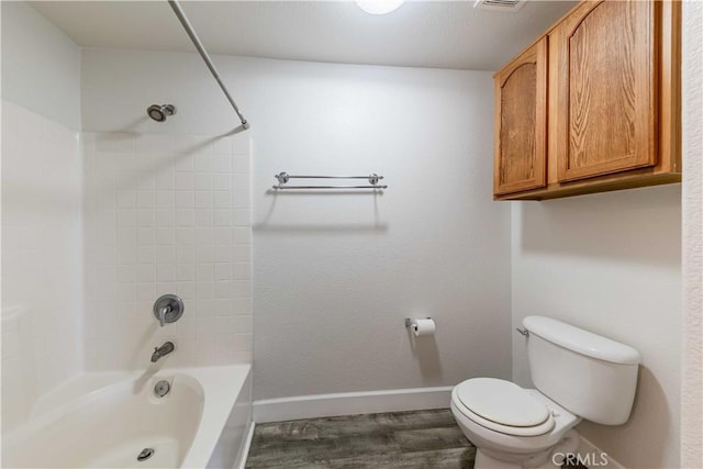 bathroom with toilet,  shower combination, and hardwood / wood-style flooring