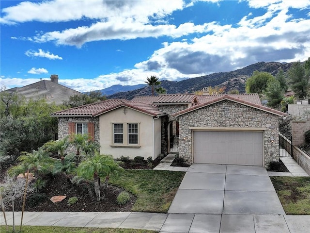 view of front facade featuring a garage and a mountain view