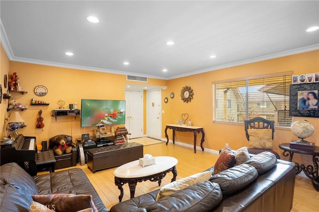 living room featuring crown molding and light hardwood / wood-style floors