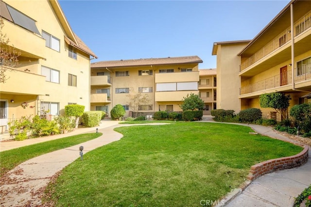 view of home's community featuring a yard