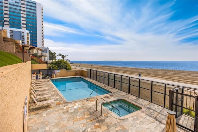 view of swimming pool featuring a water view, a community hot tub, and a patio area