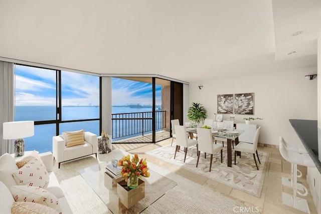 living room with expansive windows and a water view