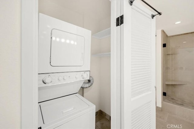 clothes washing area featuring stacked washer / drying machine