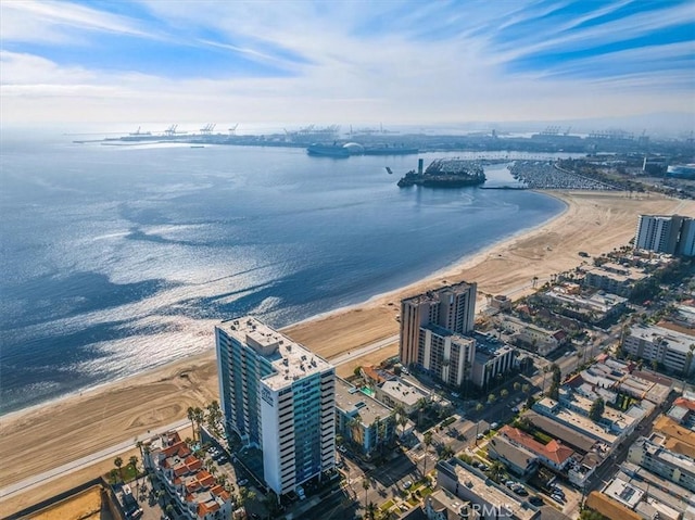 drone / aerial view featuring a water view and a beach view