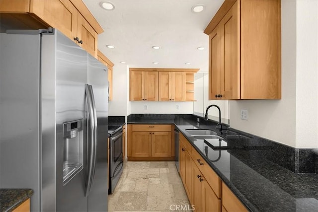 kitchen with dark stone countertops, sink, and appliances with stainless steel finishes