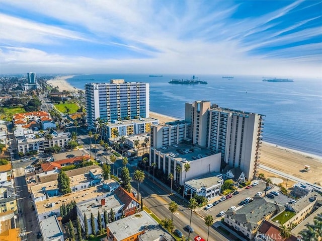 birds eye view of property with a water view and a view of the beach