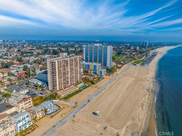 drone / aerial view featuring a water view and a beach view