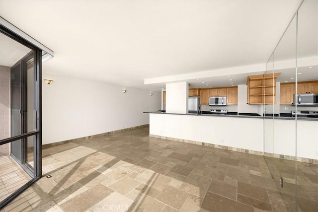 kitchen featuring appliances with stainless steel finishes and decorative light fixtures