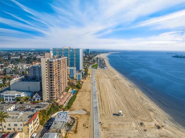 birds eye view of property with a water view and a view of the beach