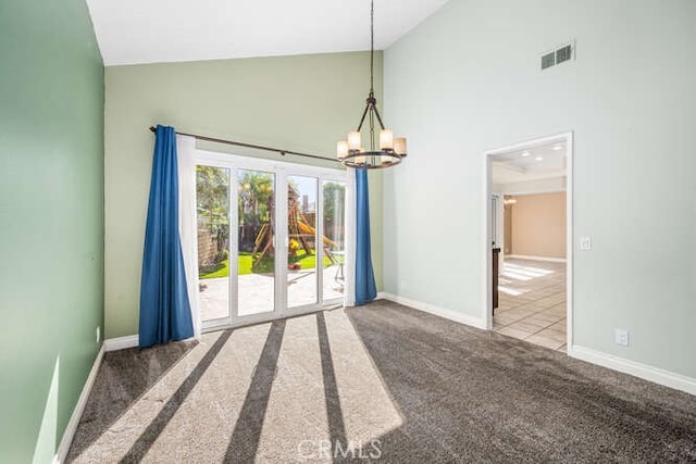 unfurnished room featuring an inviting chandelier, carpet, and high vaulted ceiling