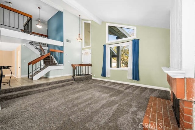 living room featuring beam ceiling, dark carpet, and high vaulted ceiling