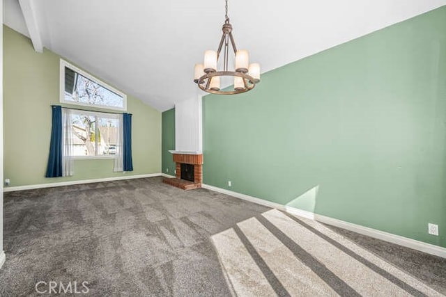 unfurnished living room with a brick fireplace, lofted ceiling, a chandelier, and carpet flooring