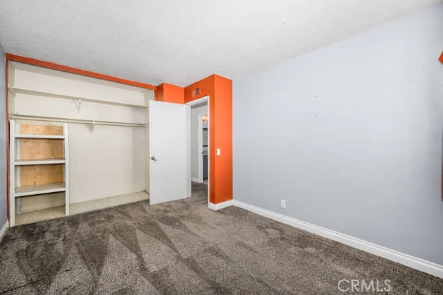 unfurnished bedroom featuring a closet and carpet flooring