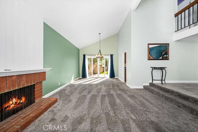 living room with carpet floors, high vaulted ceiling, and a fireplace