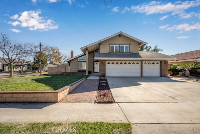 view of front of home featuring a front yard and a garage