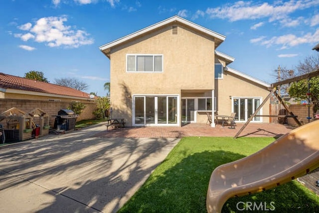 back of property featuring a patio