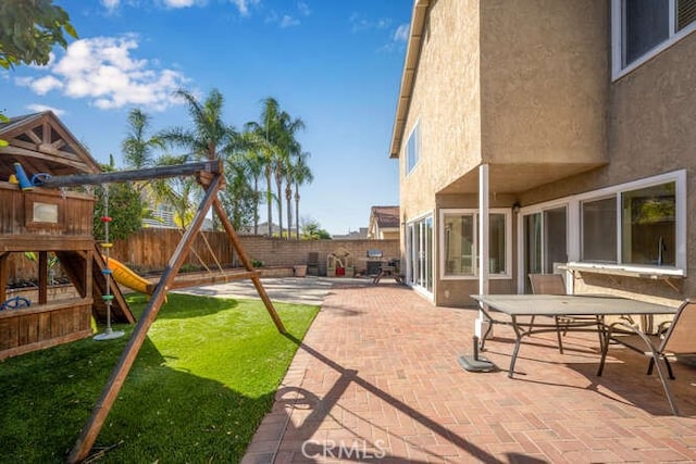 view of yard with a playground and a patio