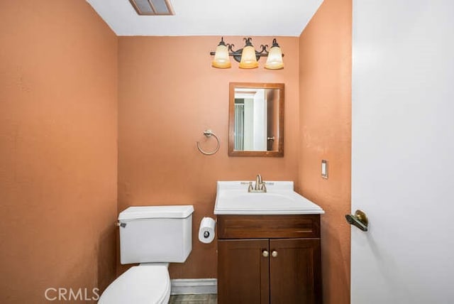 bathroom with toilet and vanity