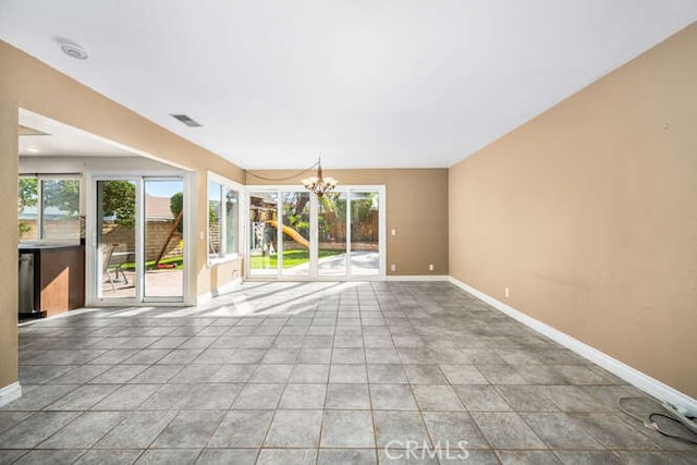 empty room featuring a notable chandelier