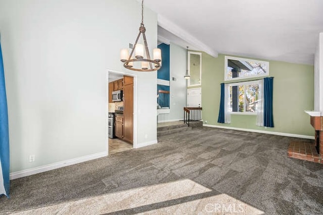 unfurnished living room featuring carpet, lofted ceiling with beams, a notable chandelier, and a brick fireplace