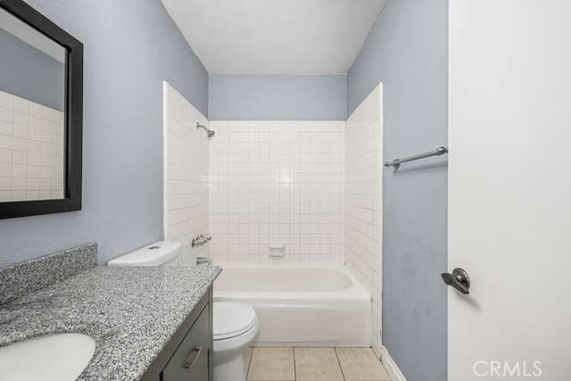 full bathroom with toilet, tile patterned floors, tiled shower / bath, and vanity