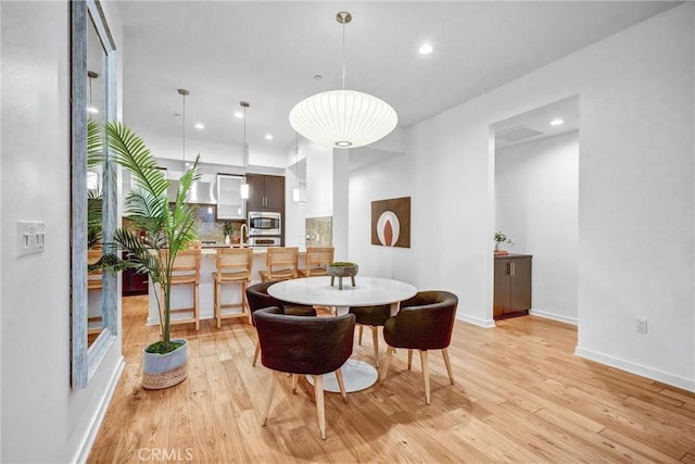 dining space featuring light wood-type flooring