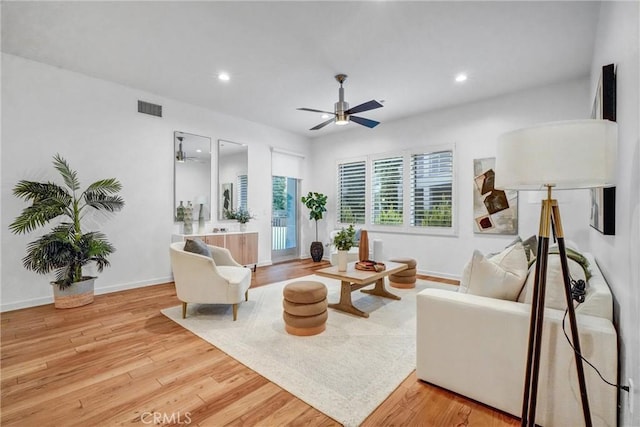 living room featuring ceiling fan and light hardwood / wood-style floors