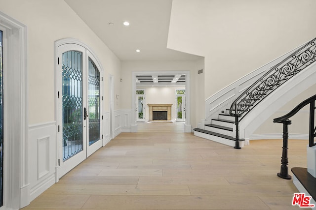 entrance foyer with french doors and light wood-type flooring