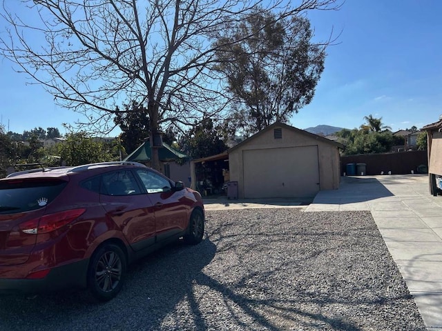 view of home's exterior featuring a garage and an outbuilding