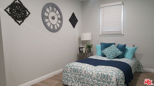 bedroom with wood-type flooring