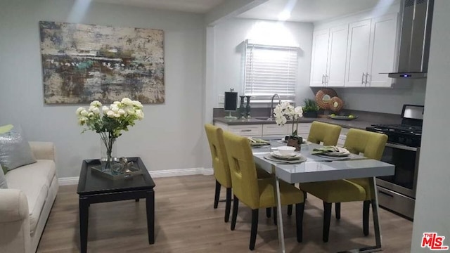 dining area featuring sink and hardwood / wood-style floors