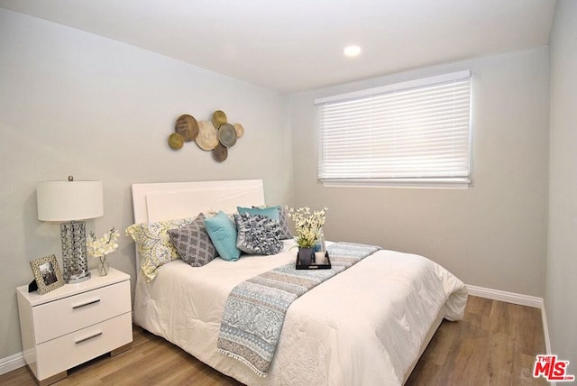 bedroom with hardwood / wood-style flooring