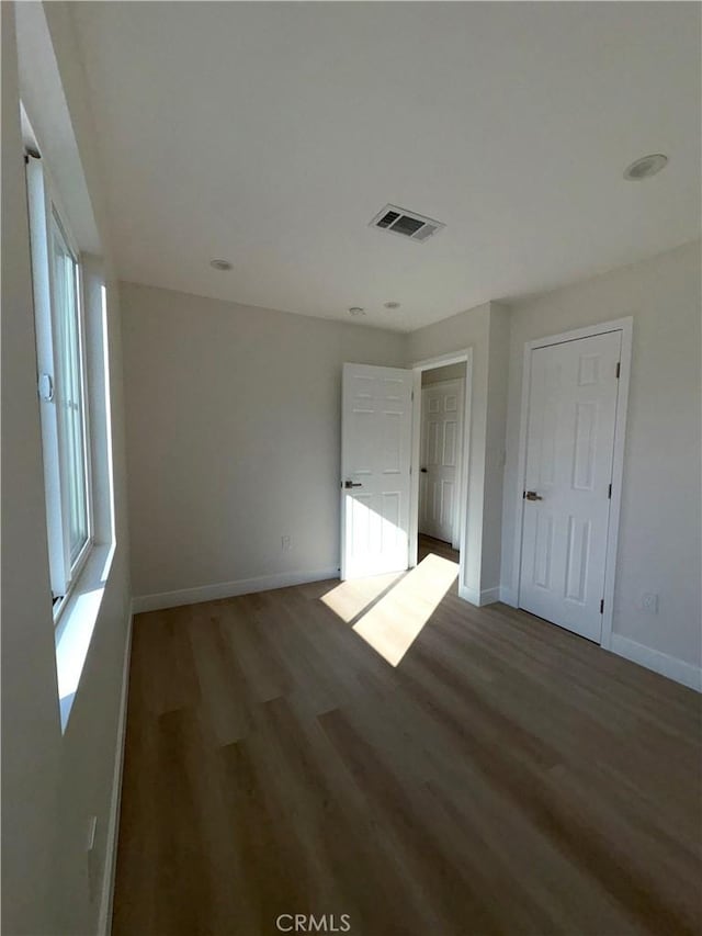 empty room featuring dark wood-type flooring