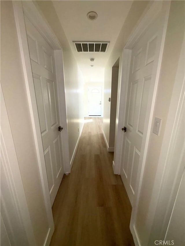 corridor featuring dark hardwood / wood-style flooring