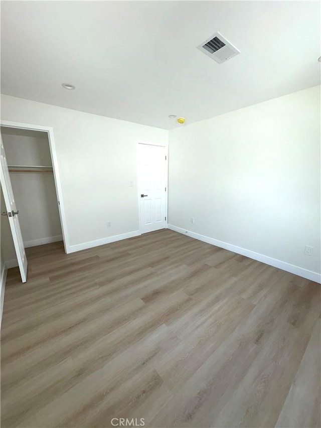 unfurnished bedroom with wood-type flooring