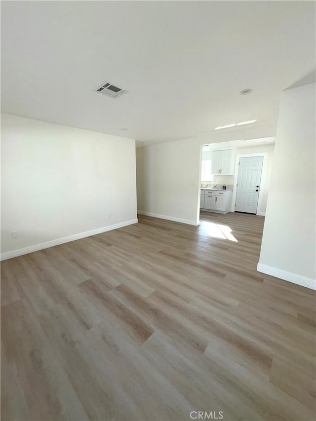 spare room featuring light wood-type flooring