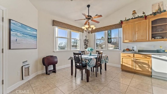 dining room with lofted ceiling, light tile patterned flooring, and baseboards