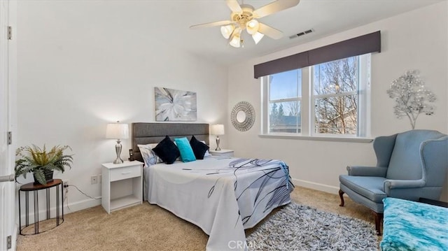 bedroom with baseboards, visible vents, a ceiling fan, and light colored carpet