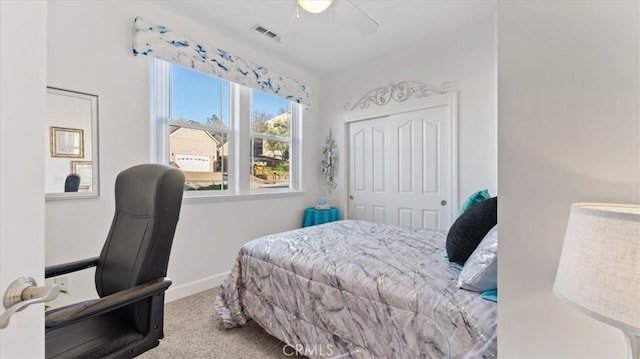 carpeted bedroom with ceiling fan, a closet, visible vents, and baseboards